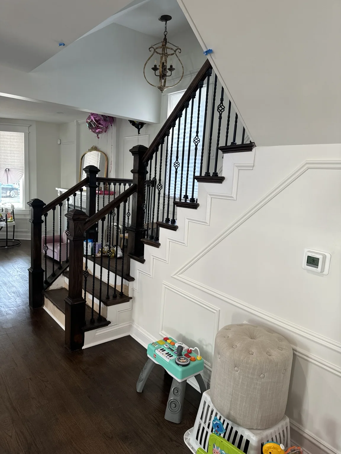 Custom staircase with dark stained wood and iron balusters